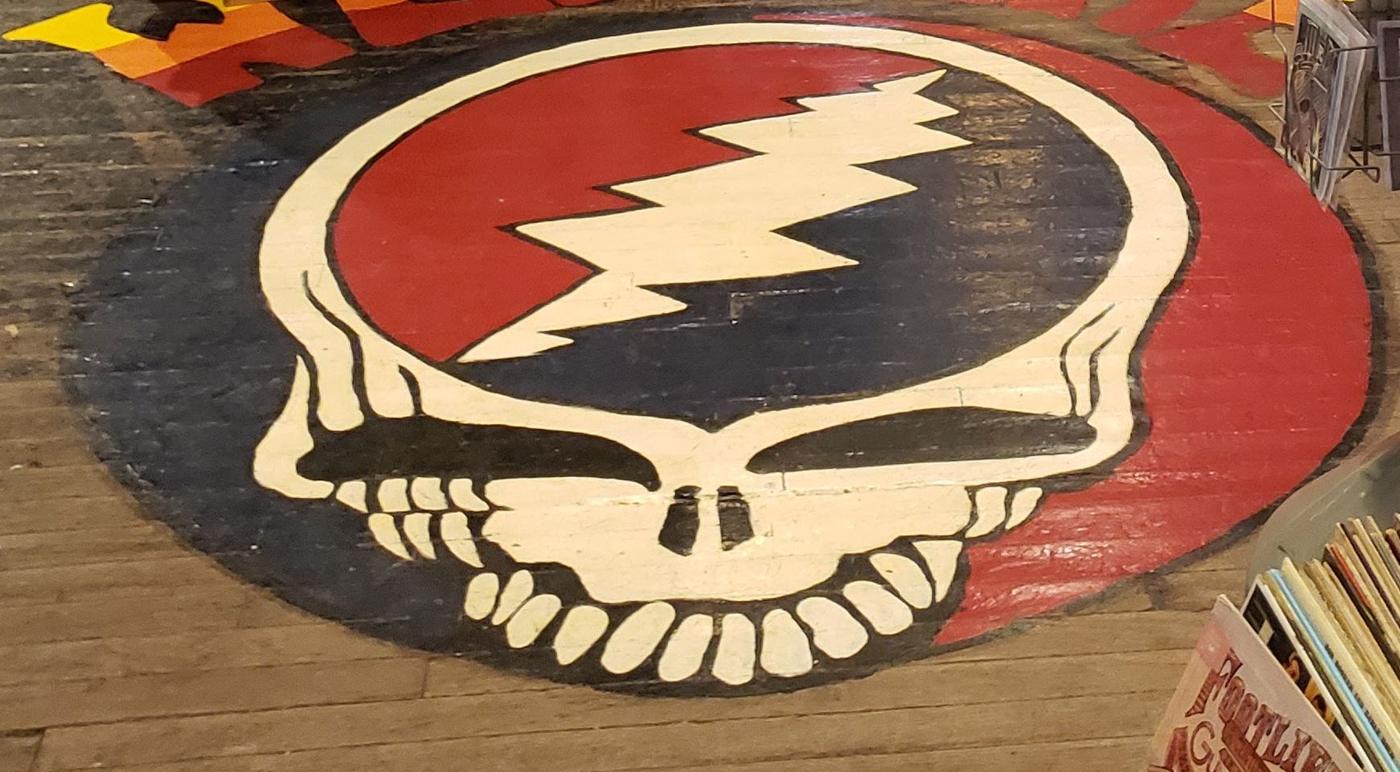 A skull and lightning bolt painted directly into the floorboards of the shop.